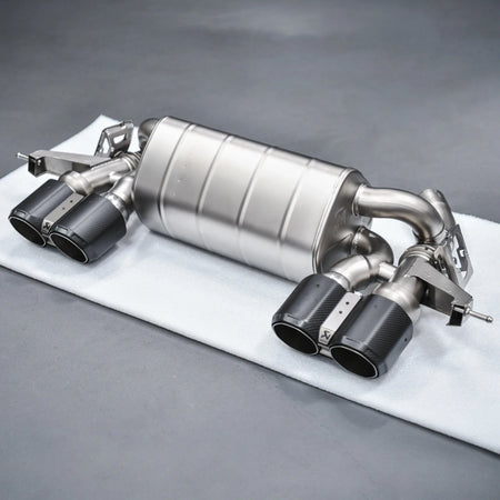 Complete Akrapovic Slip-On Line Titanium Performance Exhaust for BMW M2 G87, displayed at PERON Automotive’s Performance Workshop before installation.