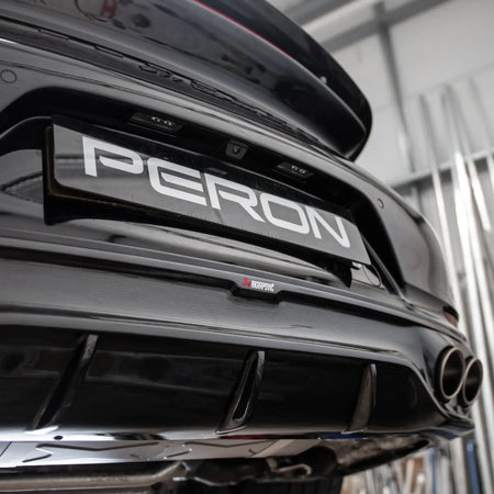 Close-up detail shot of the carbon fibre rear diffuser on a Porsche 911 Turbo S 991.2 with the Akrapovic performance exhaust installed.