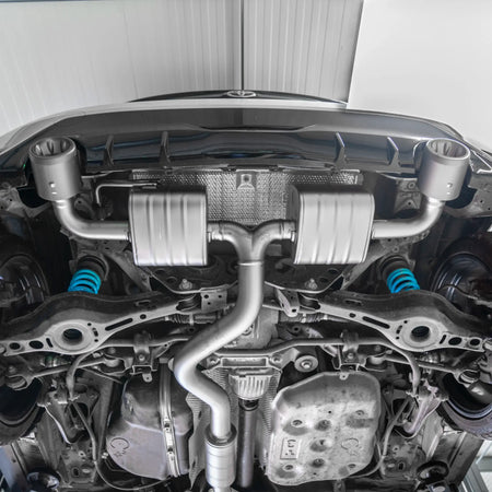 Shot from underneath the Toyota GR Yaris, showcasing the lightweight titanium construction and precise fitment of the Akrapovič Slip-On Race Line (Titanium).