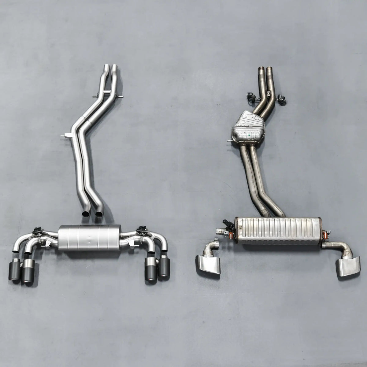Side-by-side comparison of stock exhaust and Akrapovic Evolution Line, highlighting size difference and superior build quality.