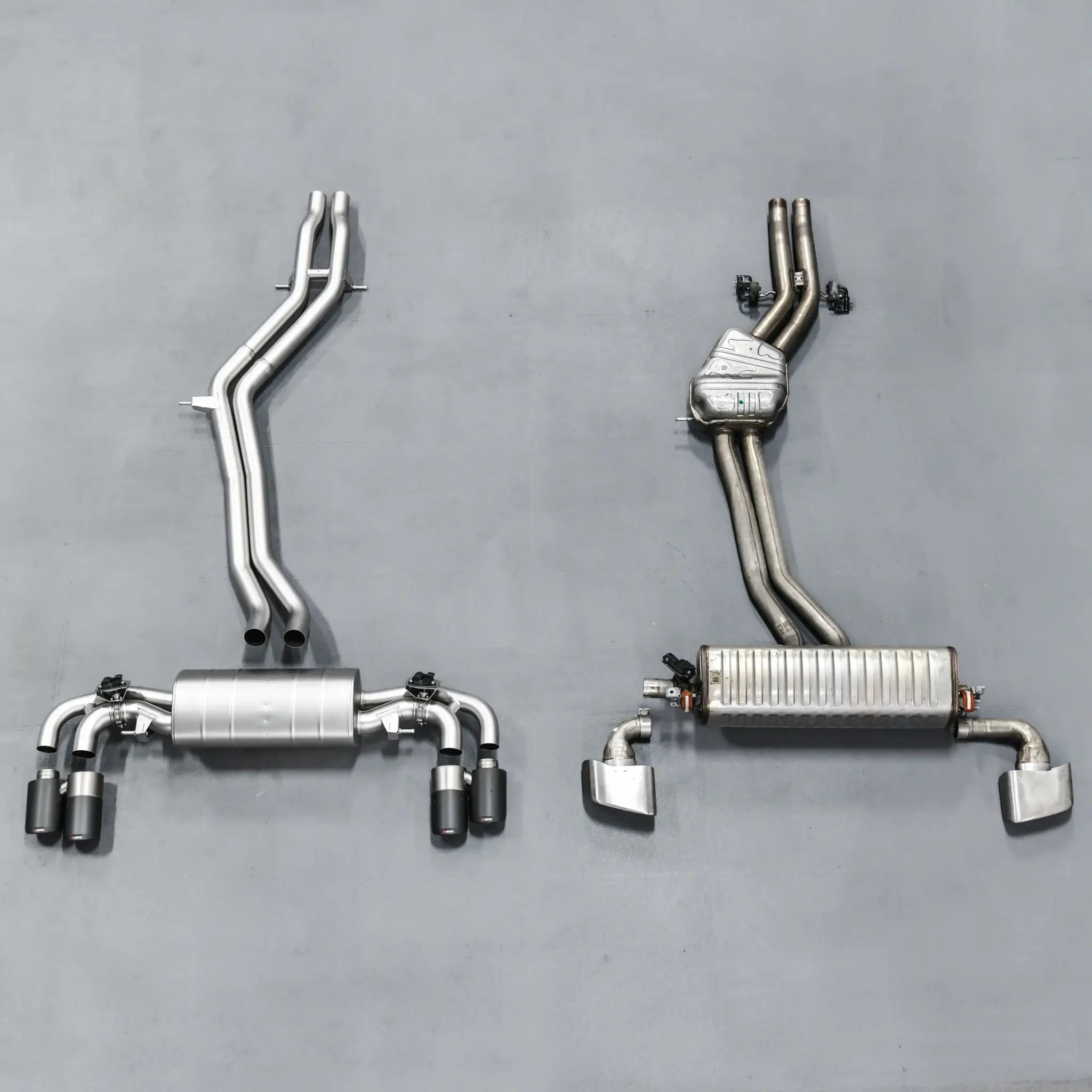 Side-by-side comparison of stock exhaust and Akrapovic Evolution Line, highlighting size difference and superior build quality.