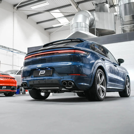 Porsche Cayenne 536.2 in Performance Workshop post-installation of Akrapovic Evolution Line titanium performance exhaust, rear angle.