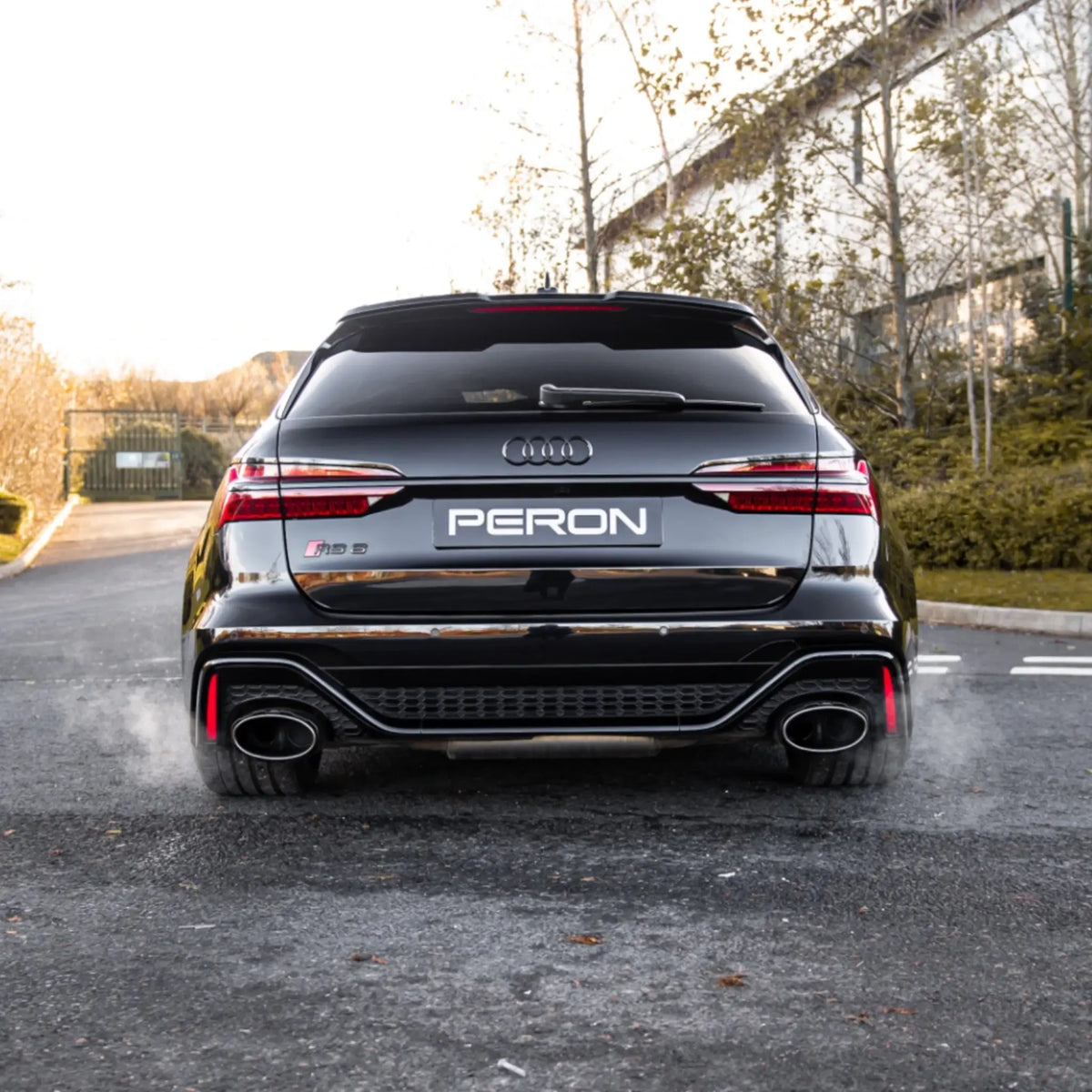 Rear shot of the Audi RS6 C8 with the Akrapovič Evolution Line (Titanium) installed, capturing the performance exhaust system and its commanding presence.
