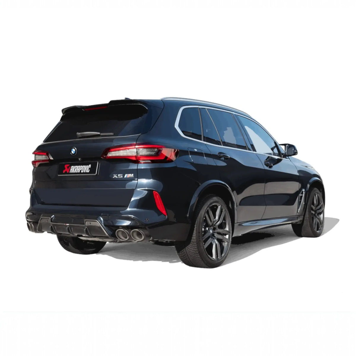 Rear angle view of BMW X5 M equipped with the Akrapovič Slip-On Line (Titanium) exhaust system, emphasising the carbon/titanium tailpipes and seamless integration.