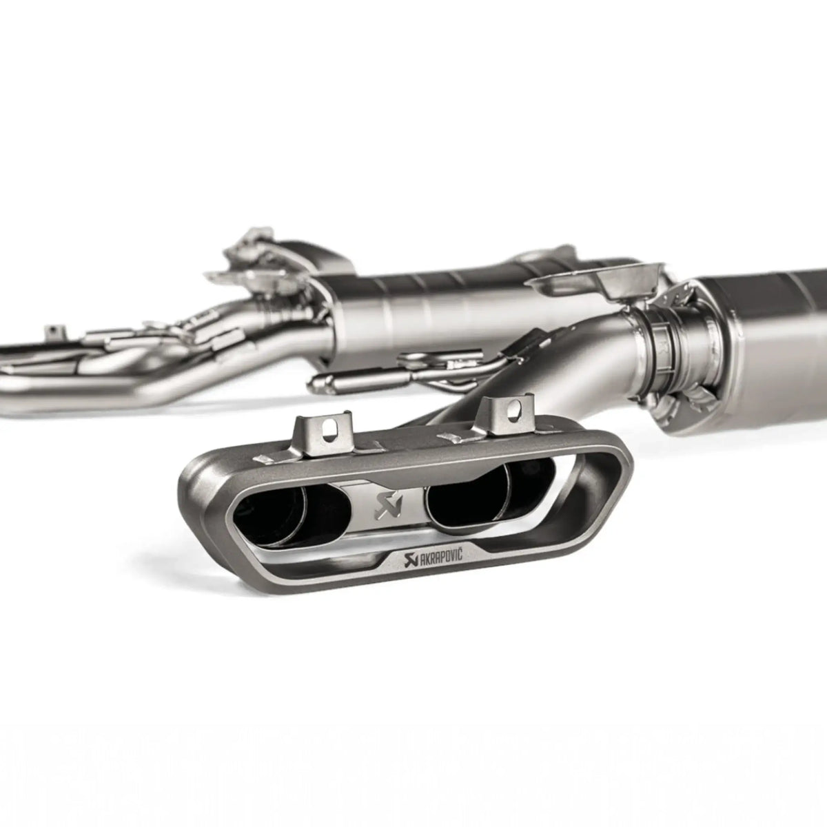 Close-up of Akrapovic dual-exit titanium tailpipes for Mercedes-AMG G 63 W463A, showcasing precision-crafted design and premium finish.