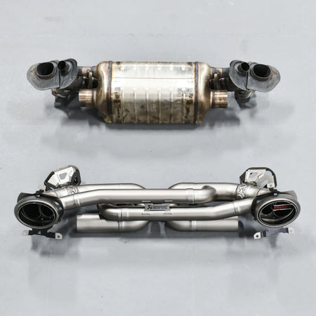 Side-by-side comparison of stock exhaust and Akrapovic Slip-On Race Line, showcasing size and build quality differences.
