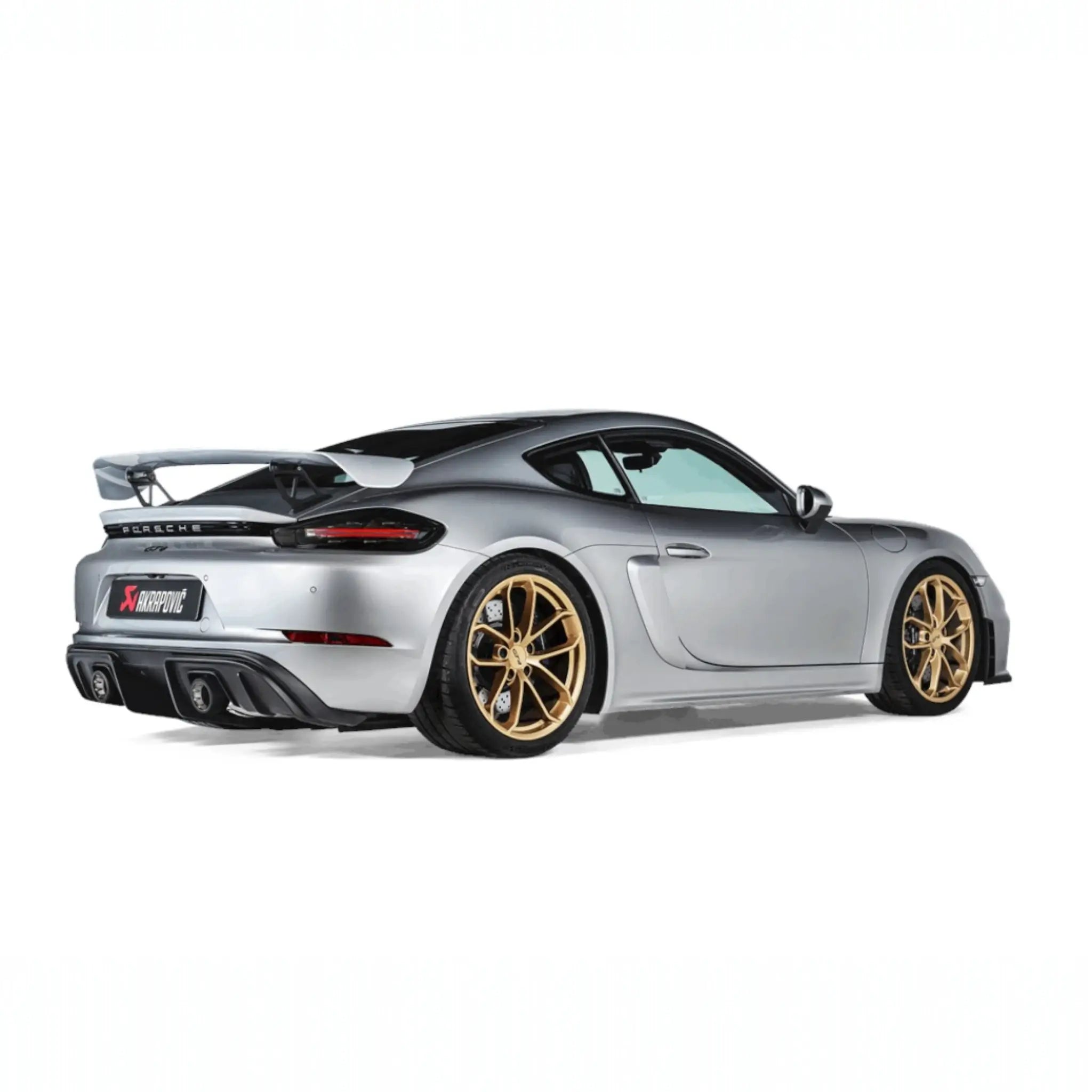 Rear angle view of Porsche 718 Cayman GT4 equipped with the Akrapovič Slip-On Race Line (Titanium), highlighting the integrated titanium tailpipes.