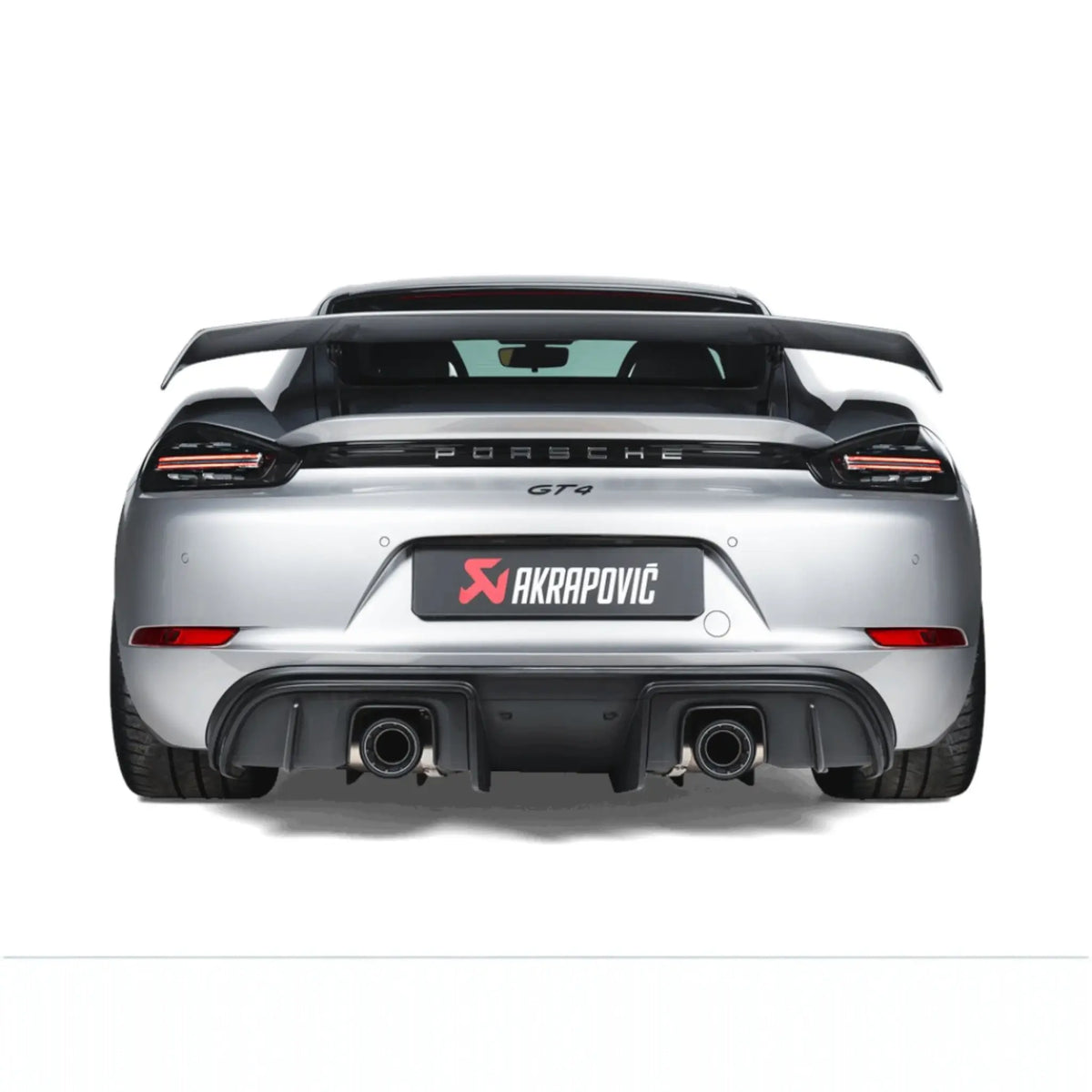 Straight rear view of Porsche 718 Cayman GT4 fitted with the Akrapovič Slip-On Race Line (Titanium), emphasising the sleek titanium tailpipes and precision fitment.