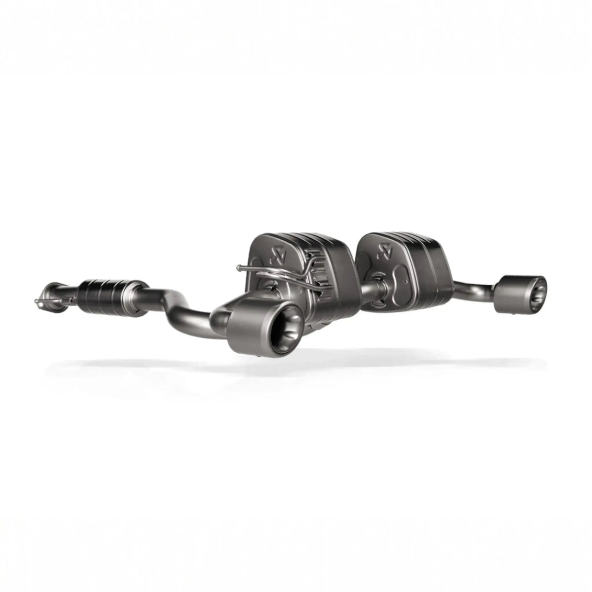 Detailed shot of the Gen 2 Akrapovič Slip-On Race Line (Titanium) exhaust system for the Toyota GR Yaris, showcasing its titanium construction and megaphone-shaped tailpipes.