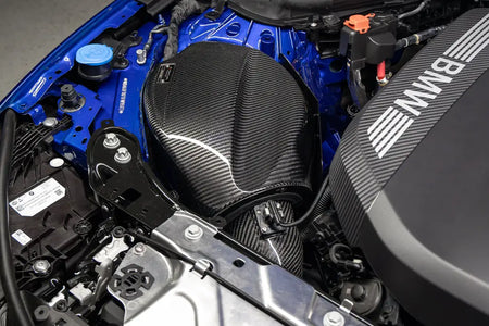 Eventuri carbon airbox and inlet tube installed next to the BMW engine cover