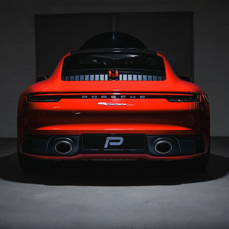 Rear head-on shot of Porsche 911 Carrera 992 in Performance Workshop post-installation of Akrapovic Slip-On Race Line exhaust.