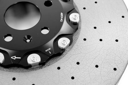 RacingLine disc bell showing the rotation arrow and mounting bolts